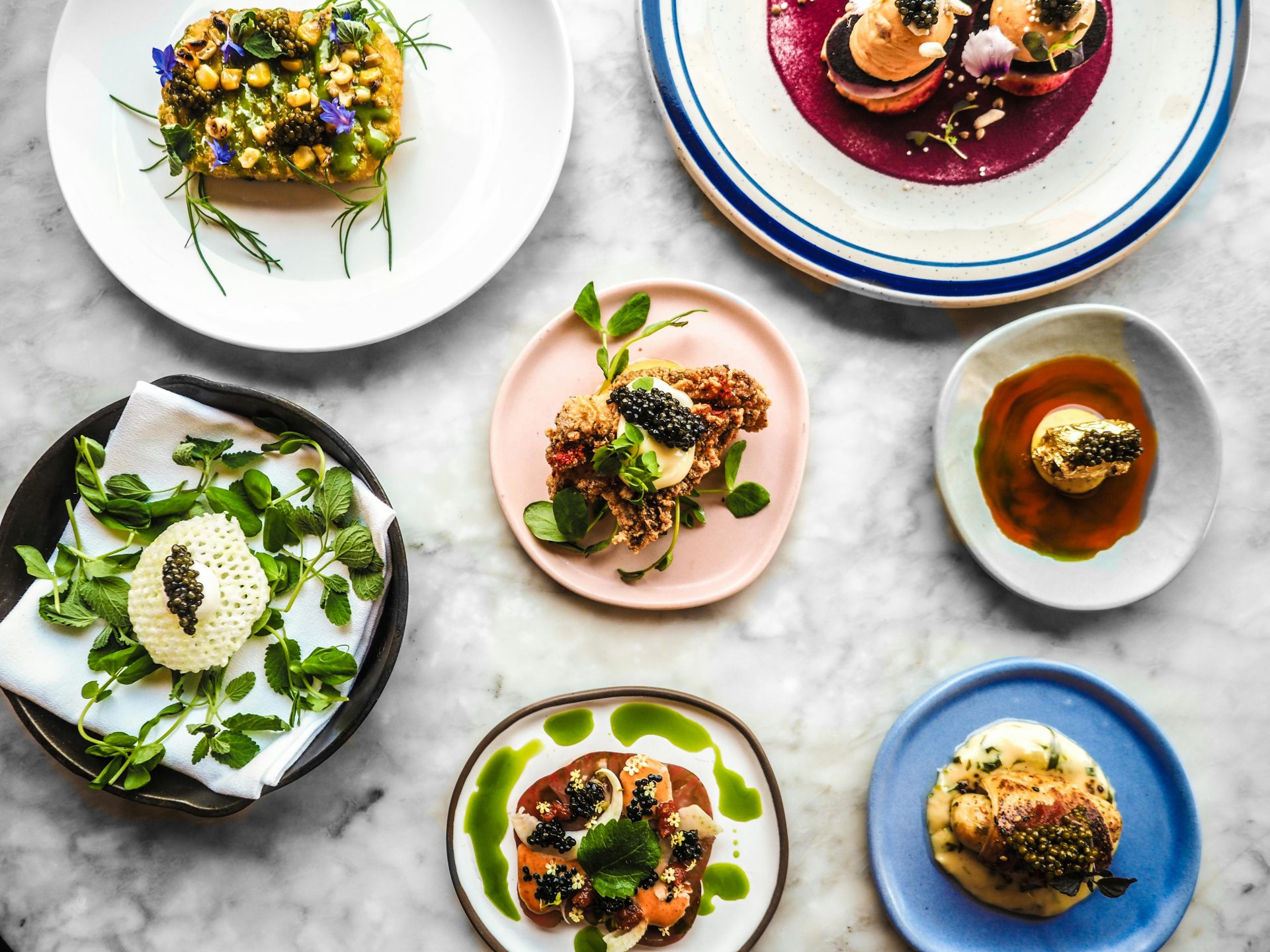 Elegant presentation of gourmet dishes topped with caviar in San Francisco.